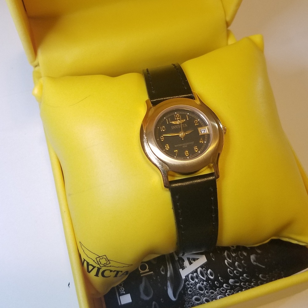 Black and gold Invicta watch in yellow box